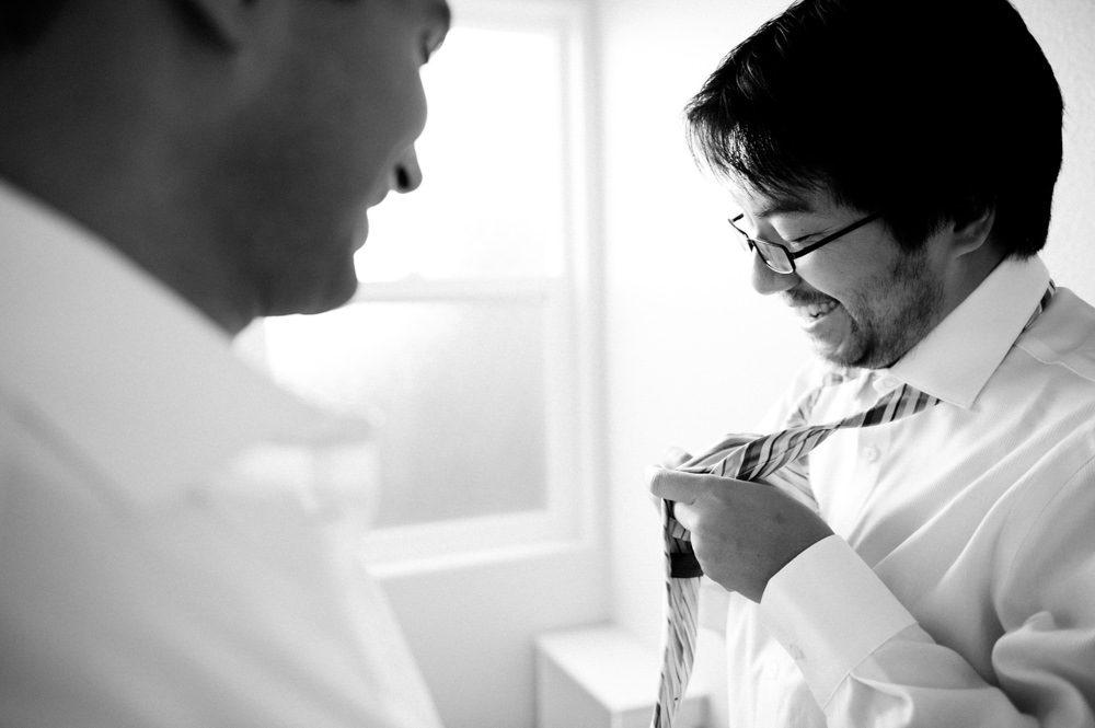 Groom Putting On Tie Wedding Portrait