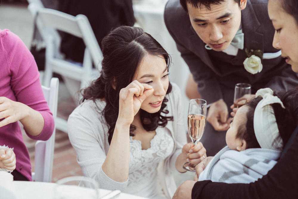 Bride plays with baby at Piedmont Community Hall wedding