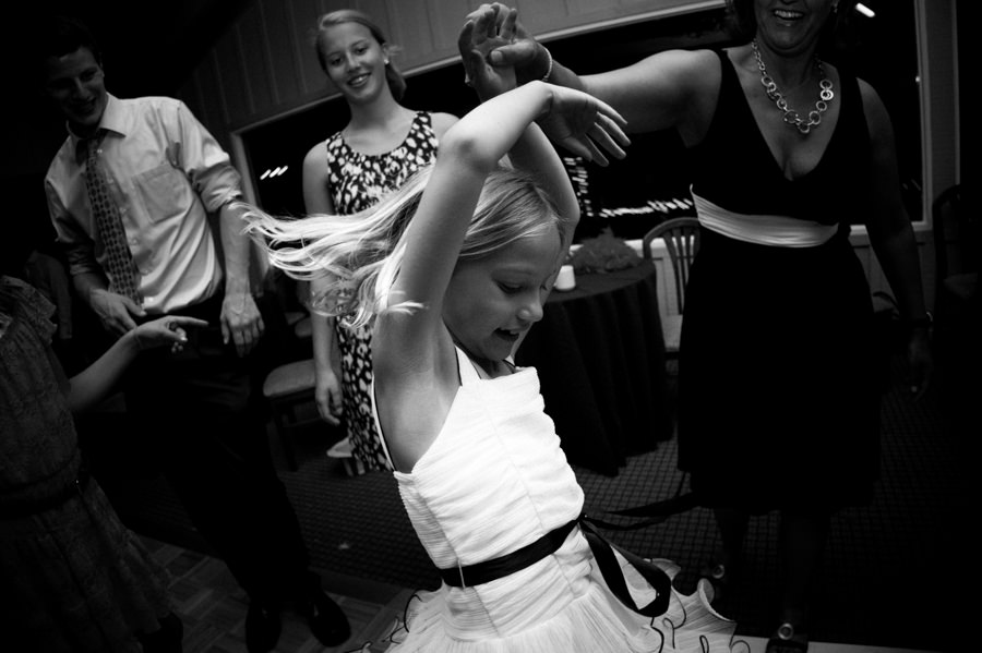 Black and white candid portrait of child dancing during wedding at Mountain Terrace