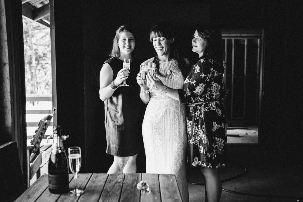 Black and white bridesmaid drinking wine in cabin