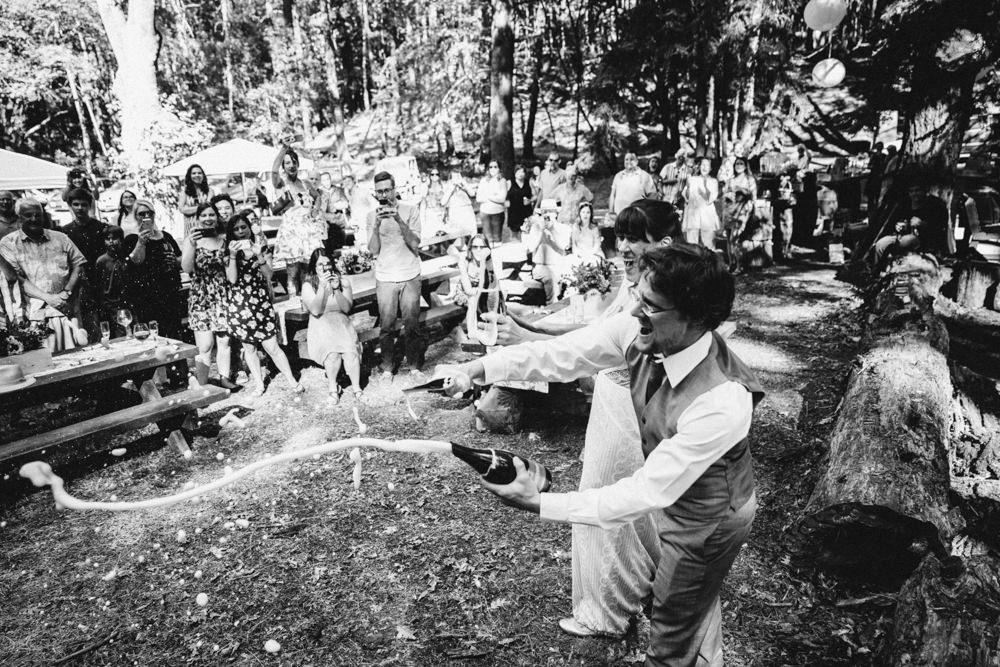 Perfect champagne saberage moment captured during napa summer wedding