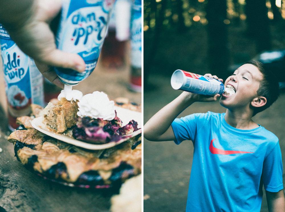 Kid eating Reddi-wip on top of pie