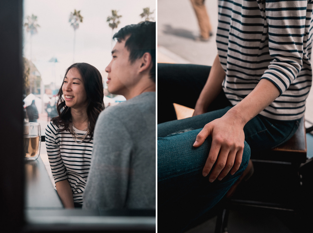 Couple looking out window at Mission Coffee engagement shoot in San Francisco