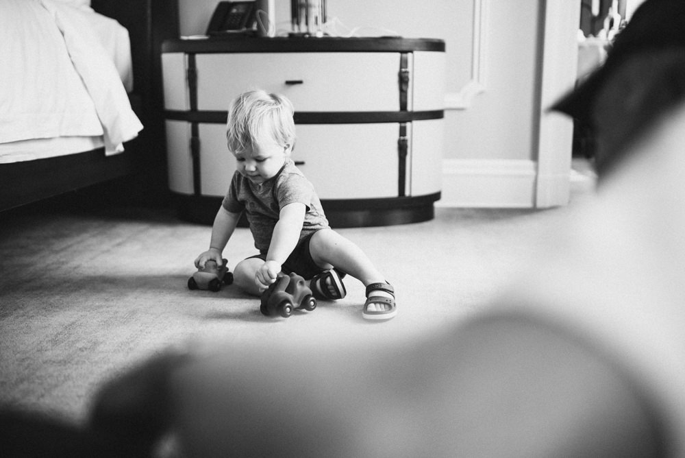 Black and white candid shot of child playing with toy