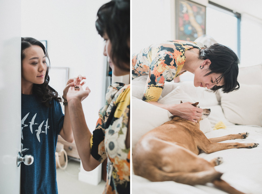 Bride getting ring from sister and playing with dog