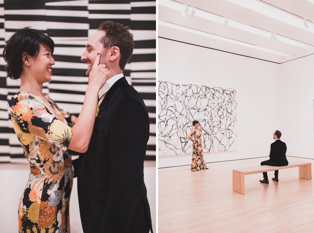 Couple posing in front of art work for wedding shoot in SF Moma