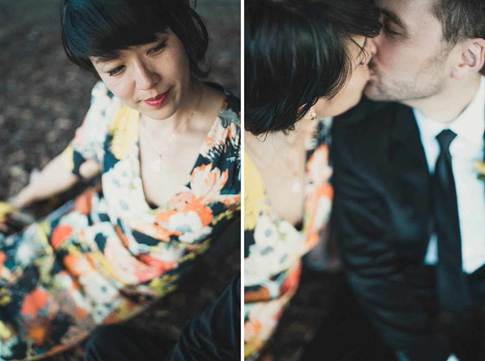 Couple kissing on ground during wedding portrait at Yerba Buena Center