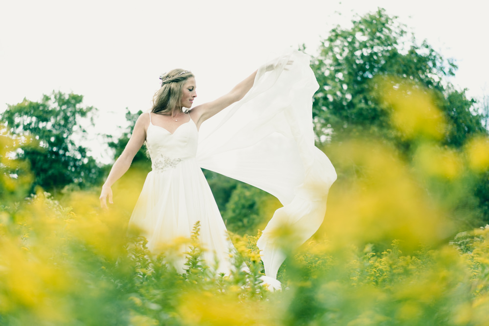 Fall themed chiffron wedding dress ideas in field of wildflowers