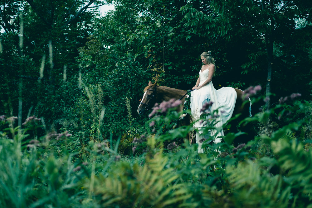 Best wedding portrait idea of bride on horse in woods