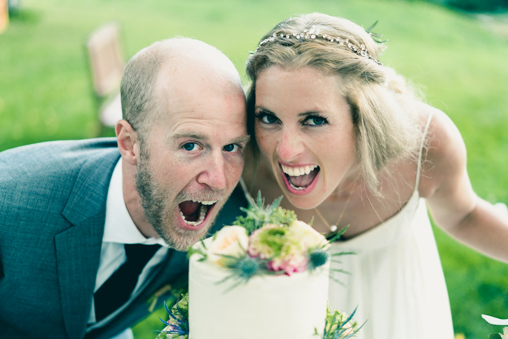 Bride and groom biting into fall themed wedding cake