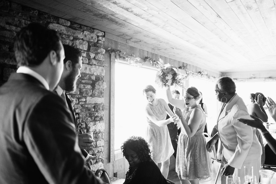 black and white shot of bridesmaid catching bouquet at wedding in Cincinnati, Ohio.