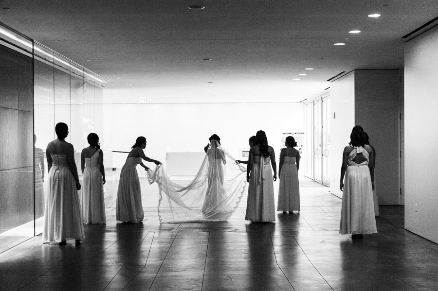 black and white candid shot of wedding party silhouette walking
