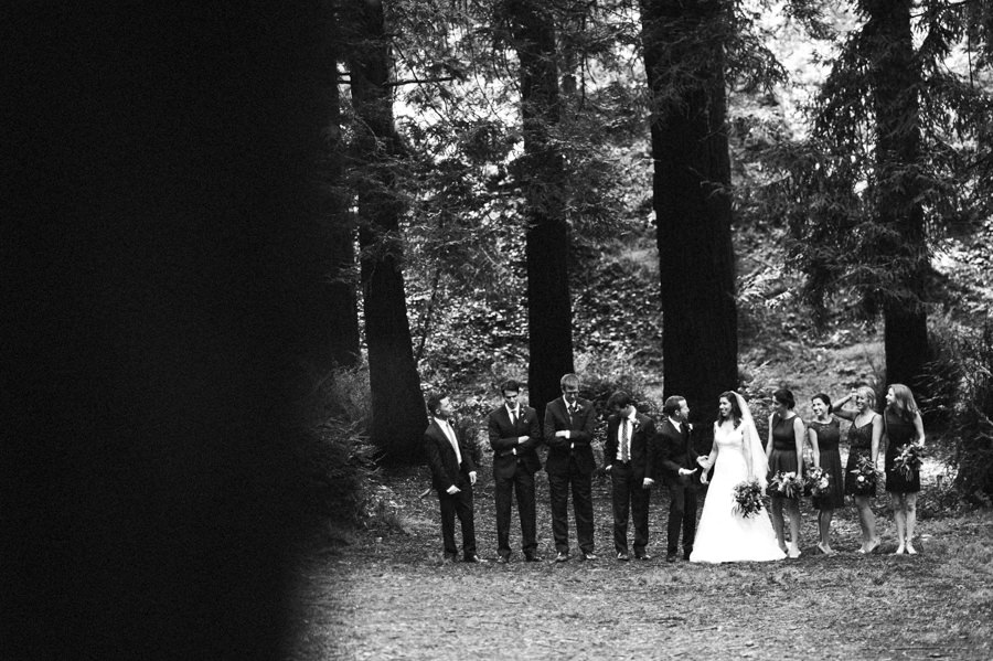 black and white candid group portrait of wedding party in golden gate park