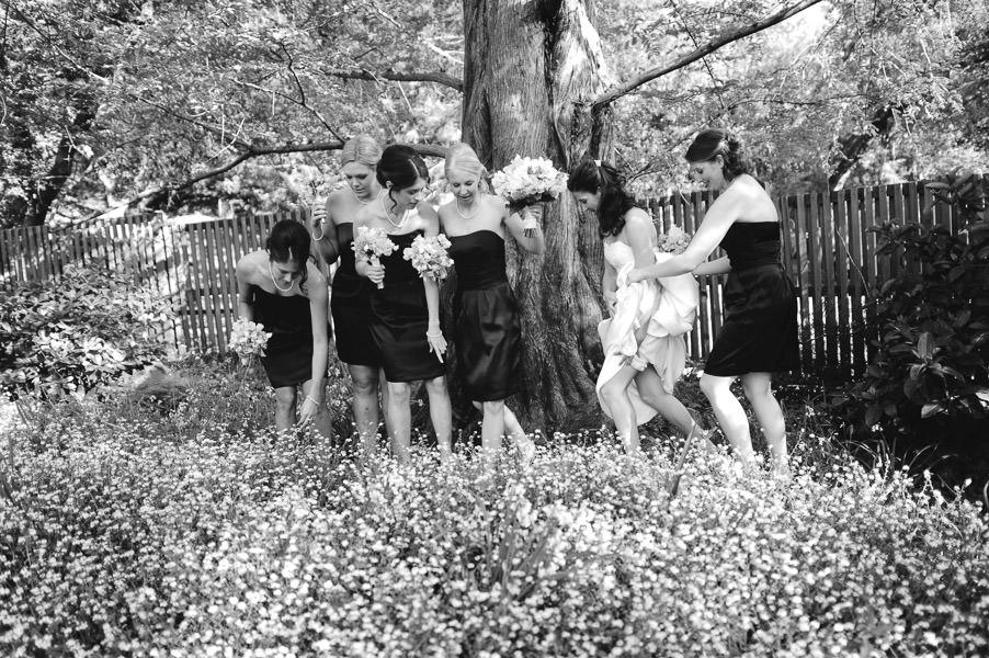 Black and white candid portrait of wedding party walking through flower field at wedding in Marin Headlands Art & Garden Center