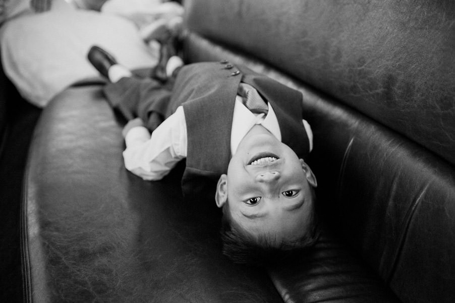 Black and white candid portrait of child laughing in limousine in Napa Valley wedding